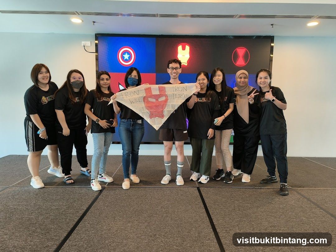 Team Poses with Marvel Banner