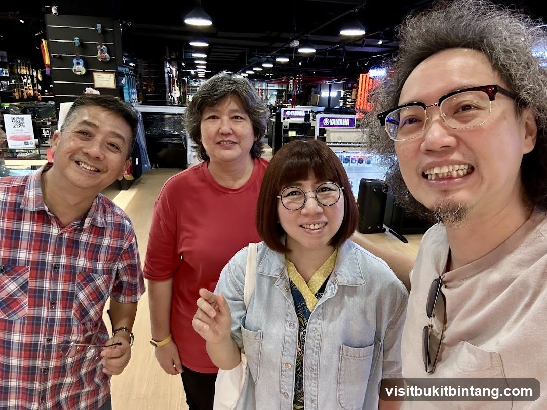 Four people smiling in a music store