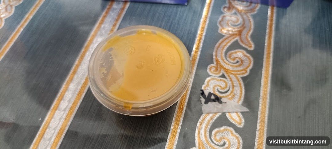 Small container of yellow substance