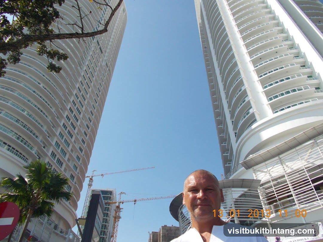 Man Posing in Front of Modern Buildings