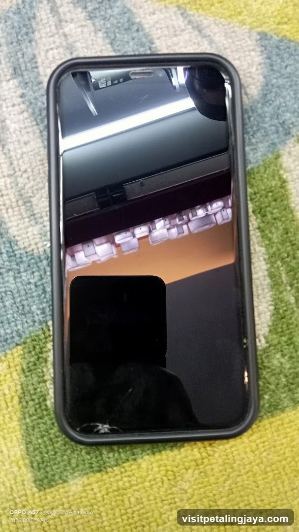 Smartphone with cracked screen on patterned fabric