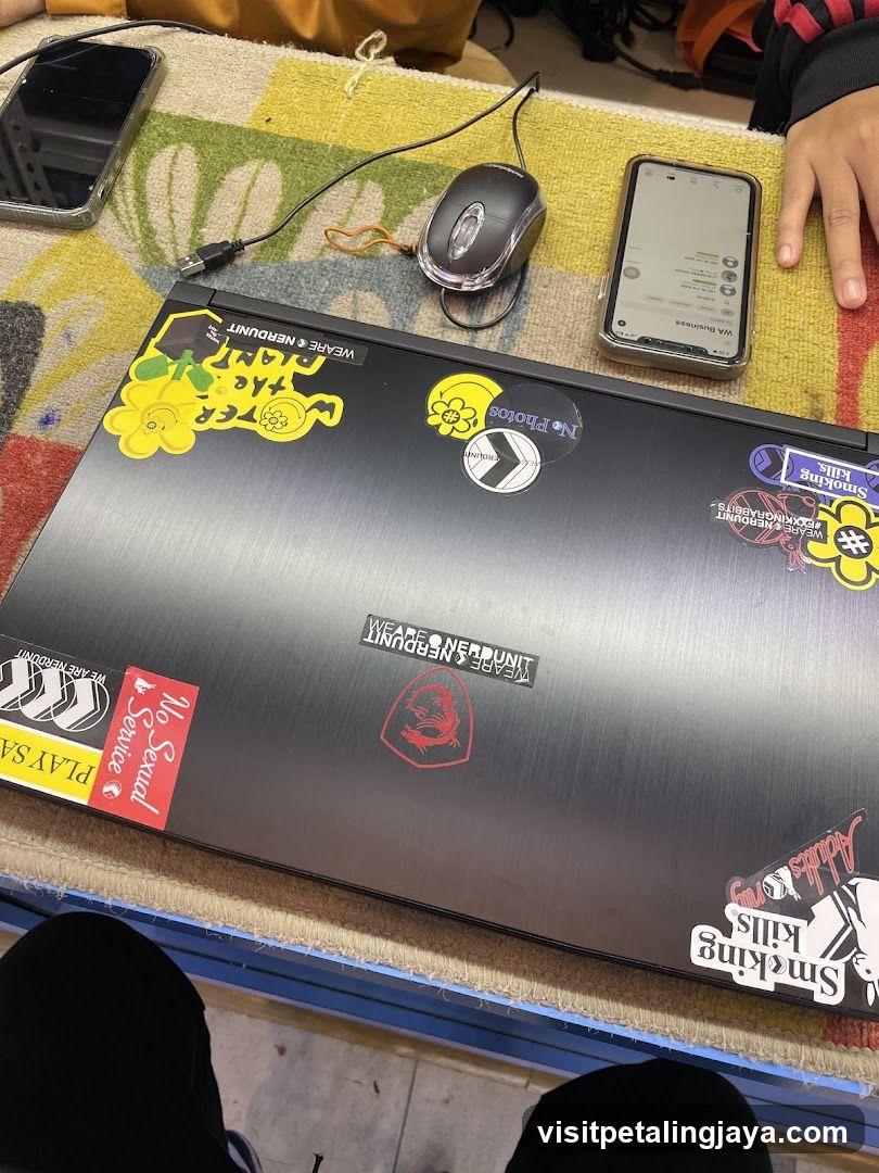 Laptop with stickers on table