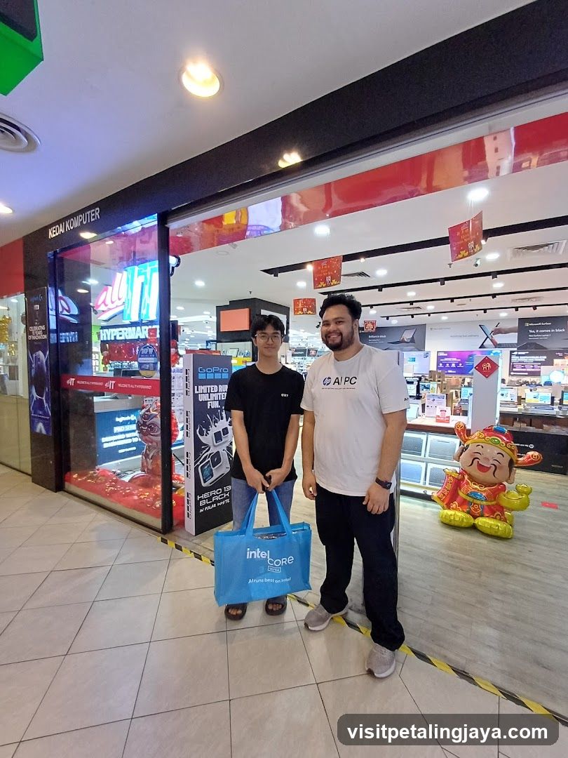 Two men standing in a mall corridor near electronics store entrance