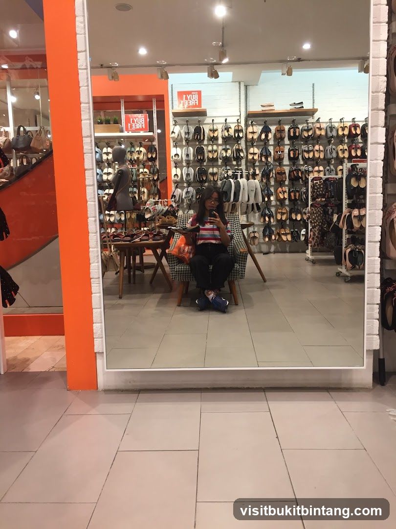 Woman taking a mirror selfie in a shoe store