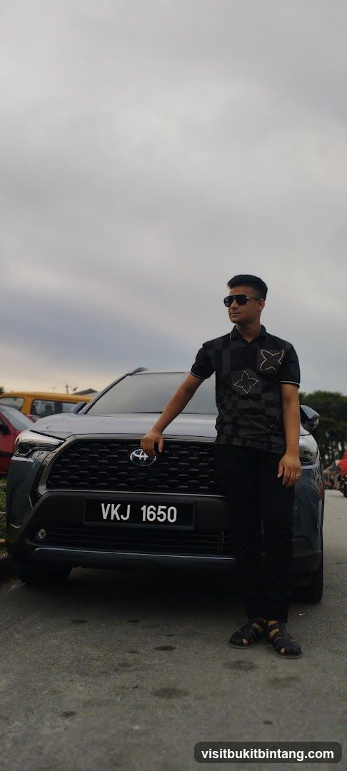 Man posing with a car