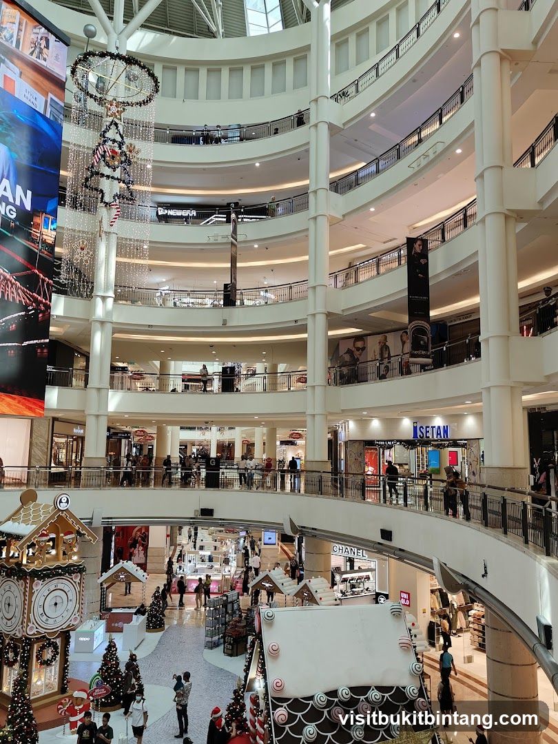 Multi-level shopping mall interior with Christmas decorations