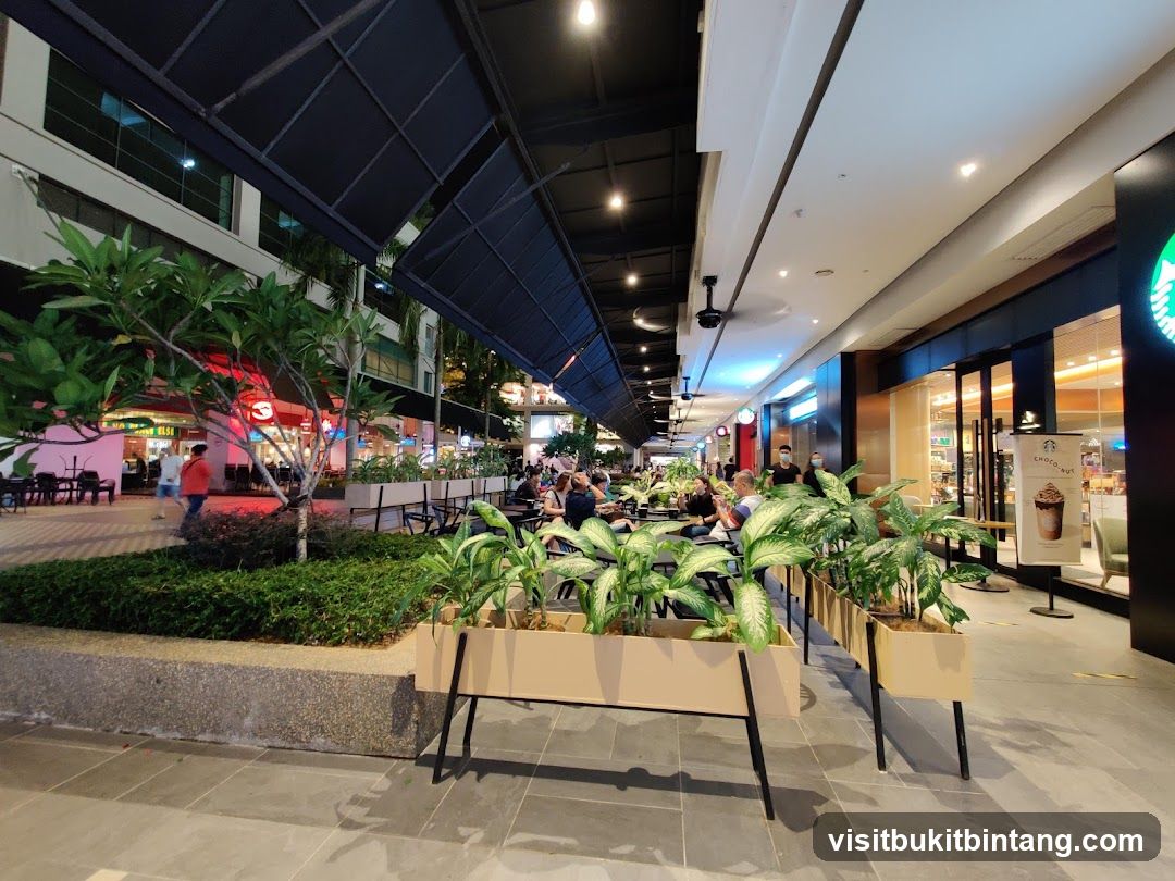 Outdoor seating area with plants and shops