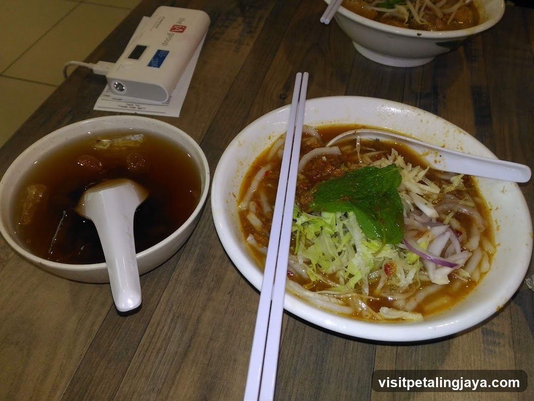 Bowl of noodles with soup and condiments