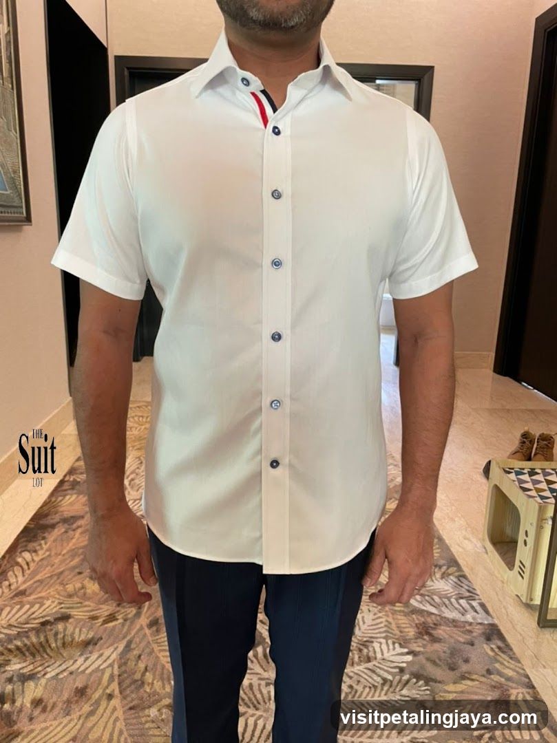 Man wearing white short-sleeve shirt and dark trousers