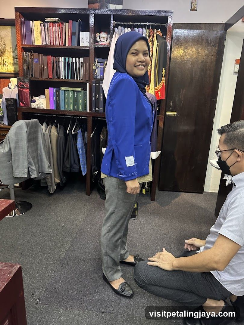 Interior of a clothing store with staff and customer