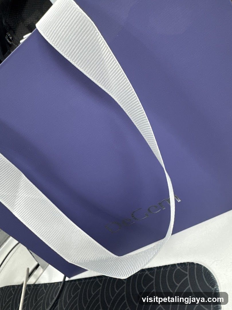 Purple tote bag with white straps