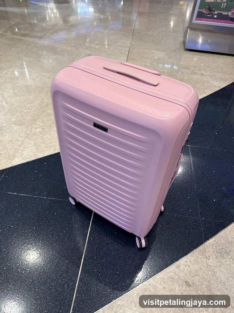 Pink Suitcase in Airport Terminal