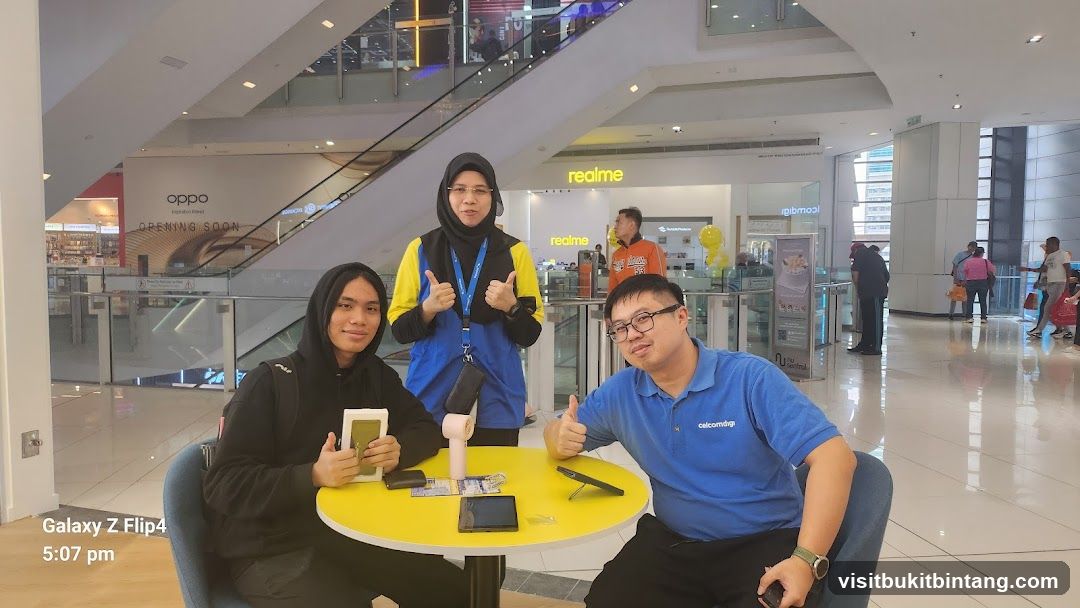 People posing at a table in a mall
