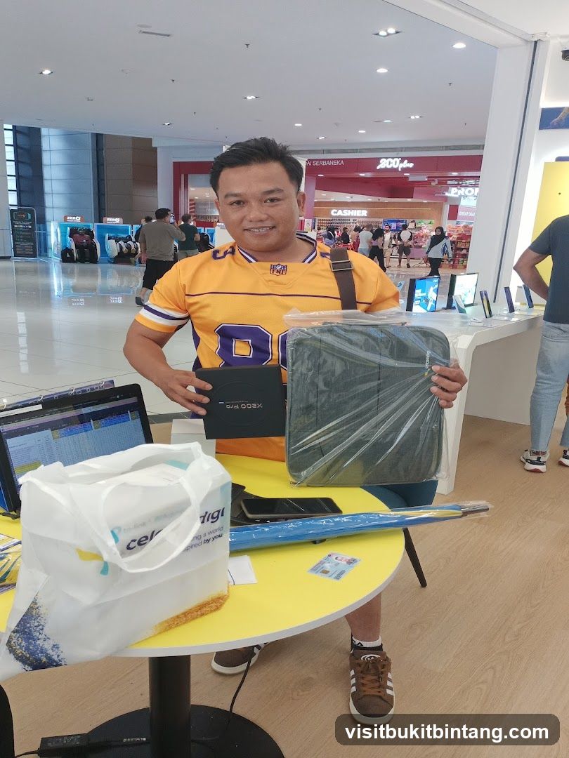 Man Holding Laptop Bag and Box