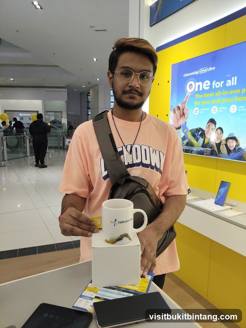 Man holding a SIM card and a mug with a company logo