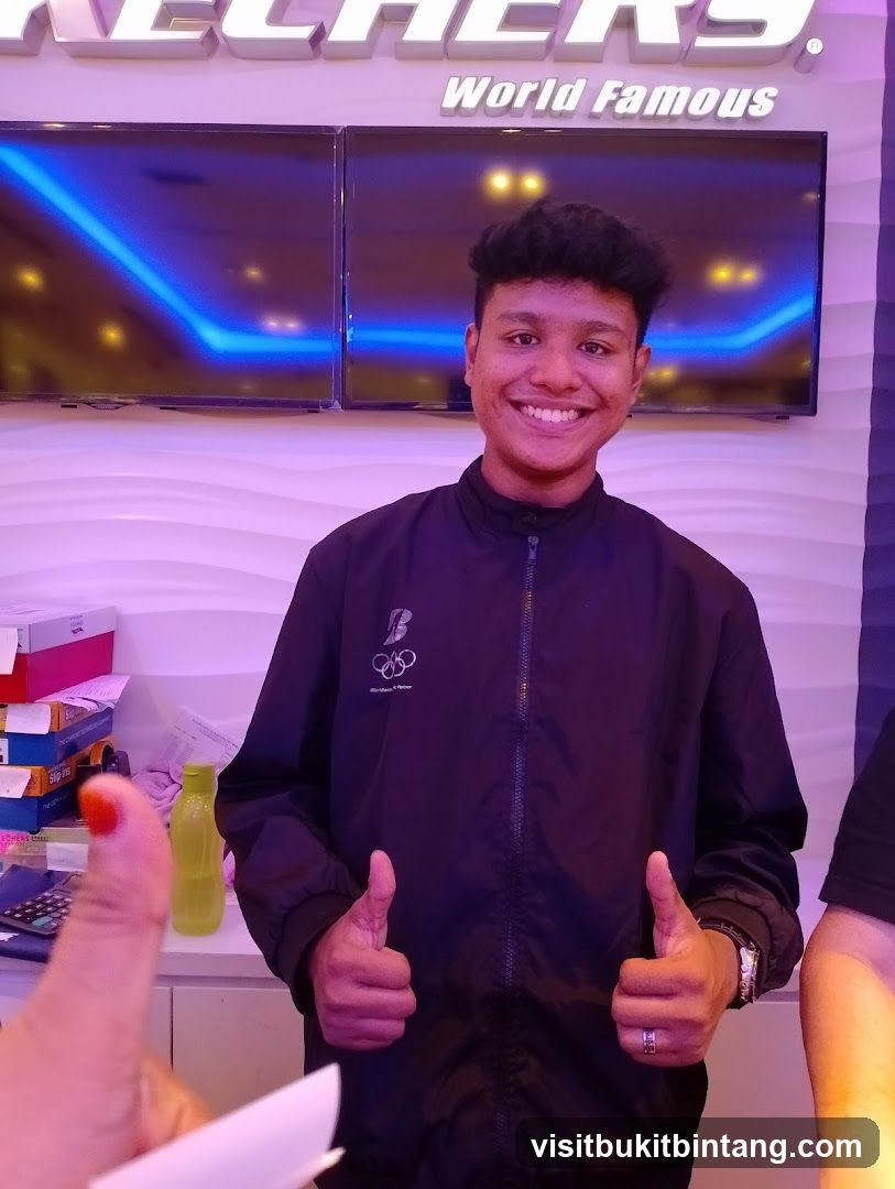 Man giving thumbs up in front of Skechers sign