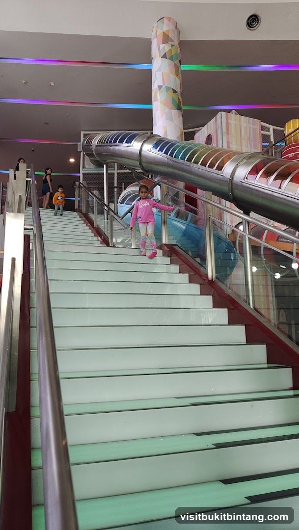 Children playing on a colorful indoor playground
