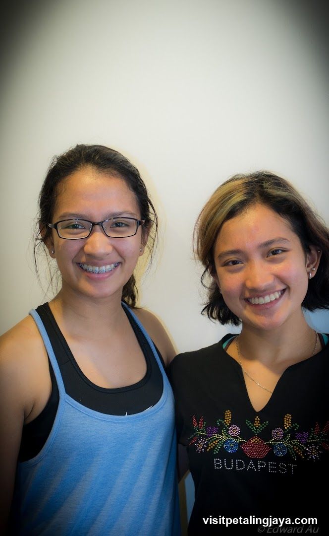Two smiling women posing together