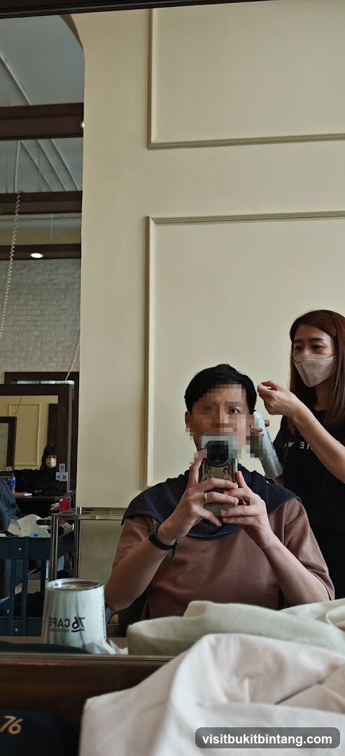 Hairdresser styling client's hair