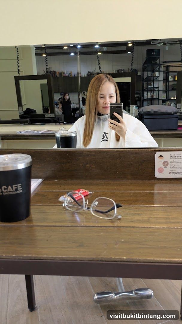 Woman taking a selfie in a salon