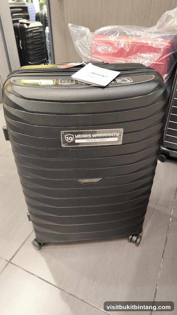 Black suitcase with warranty information