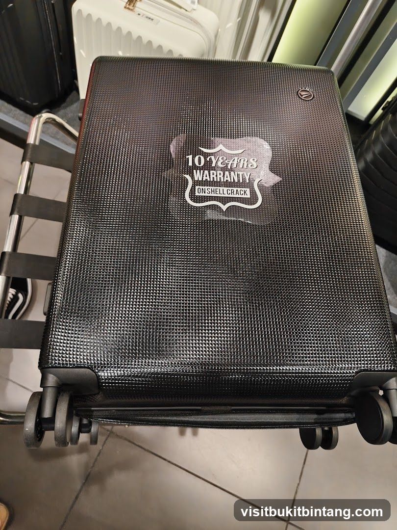 Black Suitcase with Warranty Sticker