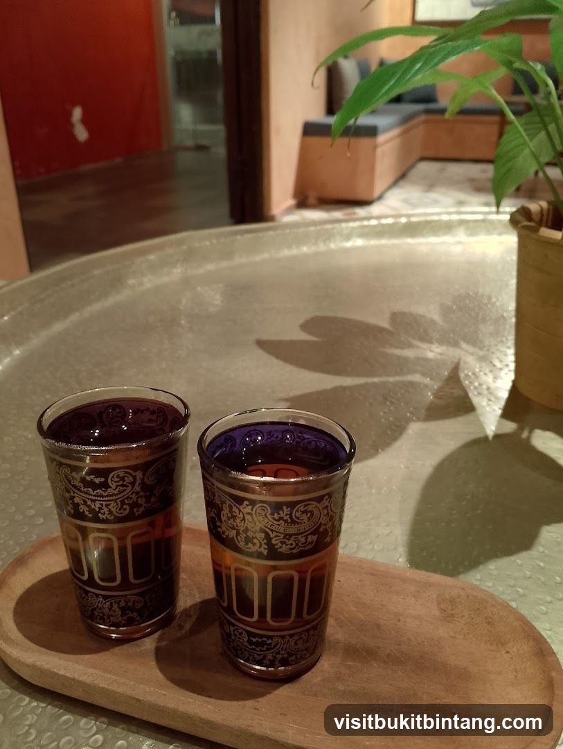 Two glasses of dark liquid on a tray