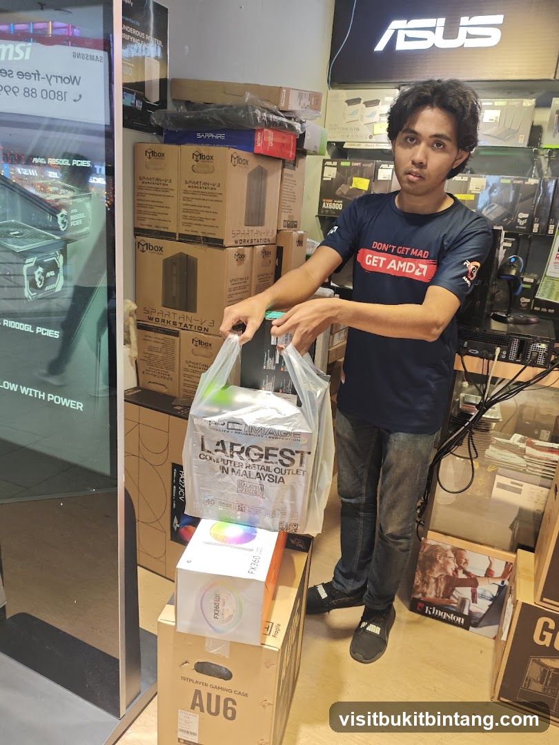 Man holding shopping bags in a computer store