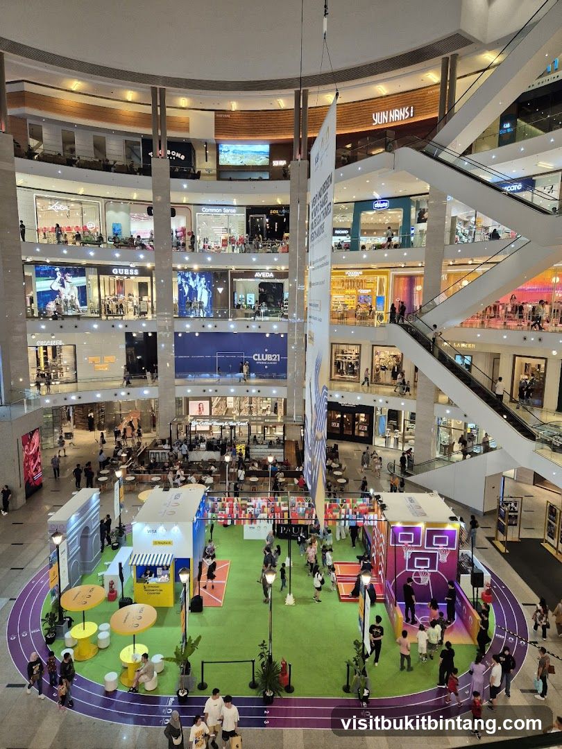 Indoor mall with various shops and a central event space