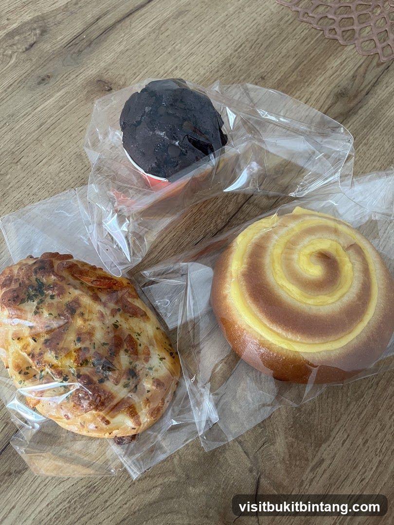 Three baked goods on a wooden surface