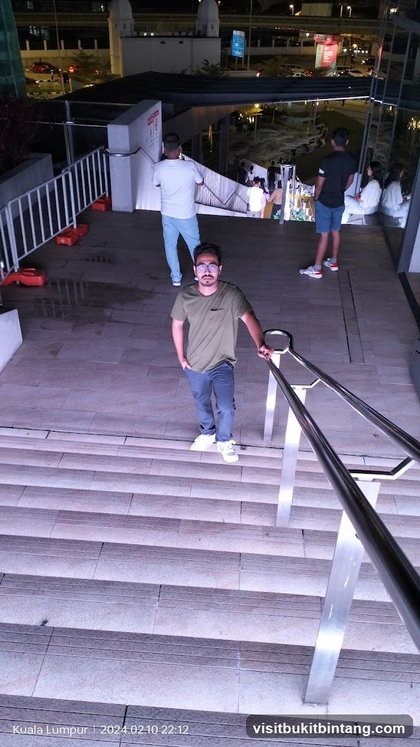 Man posing on stairs at night
