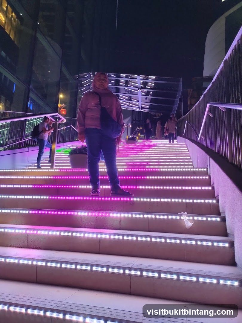 Person on illuminated stairs at night