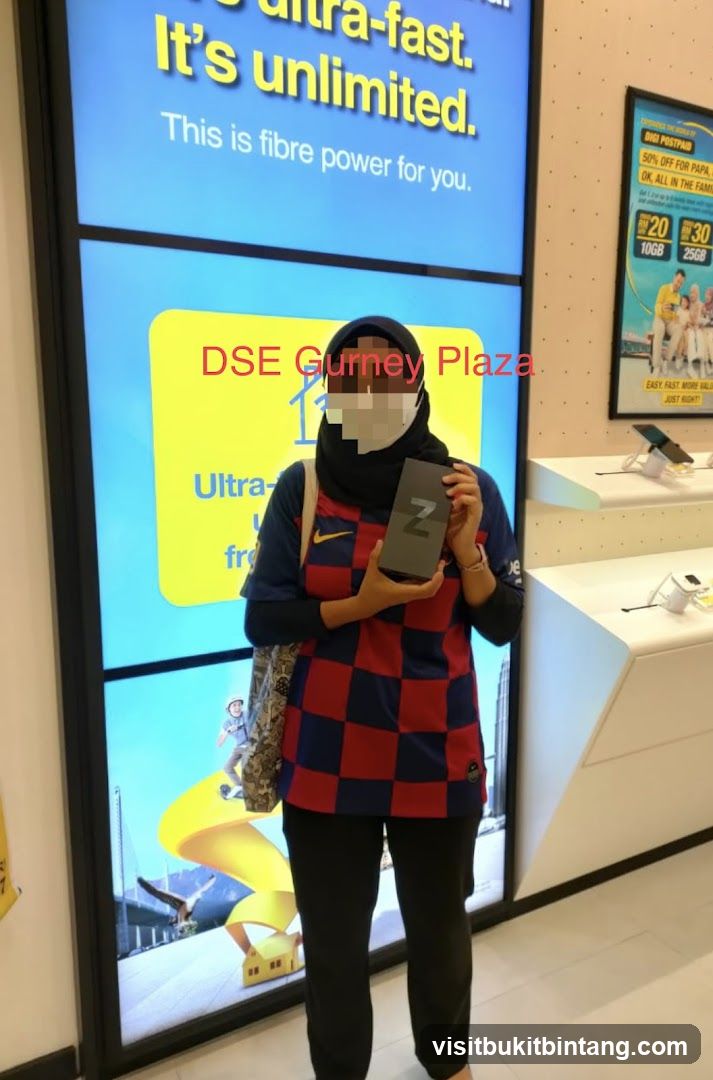 Person holding a phone box in a store