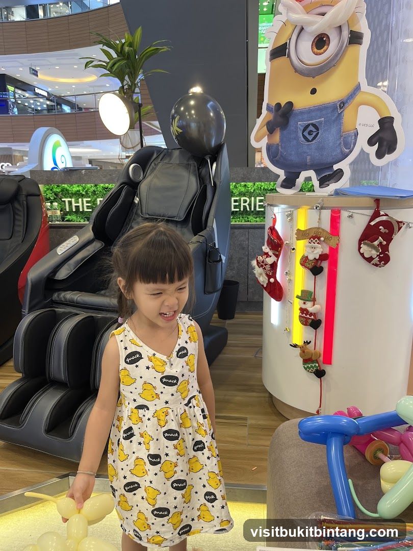 Child in front of massage chairs and Minion cutout