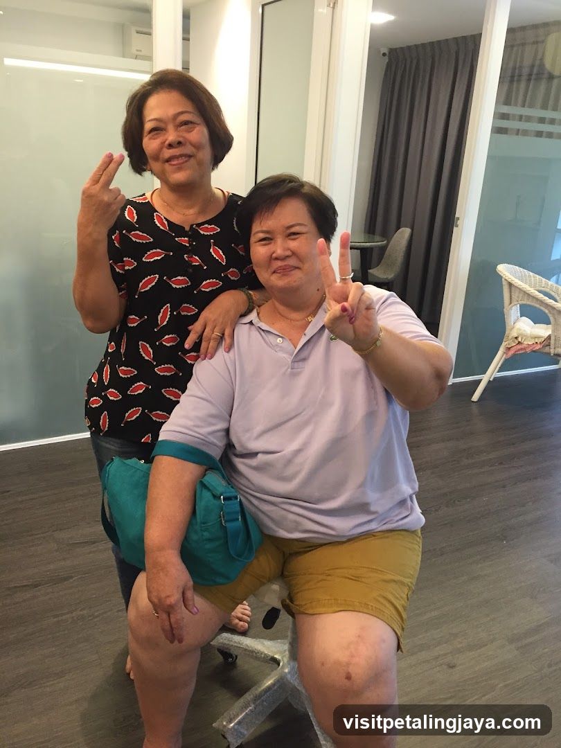 Two women posing indoors with peace signs