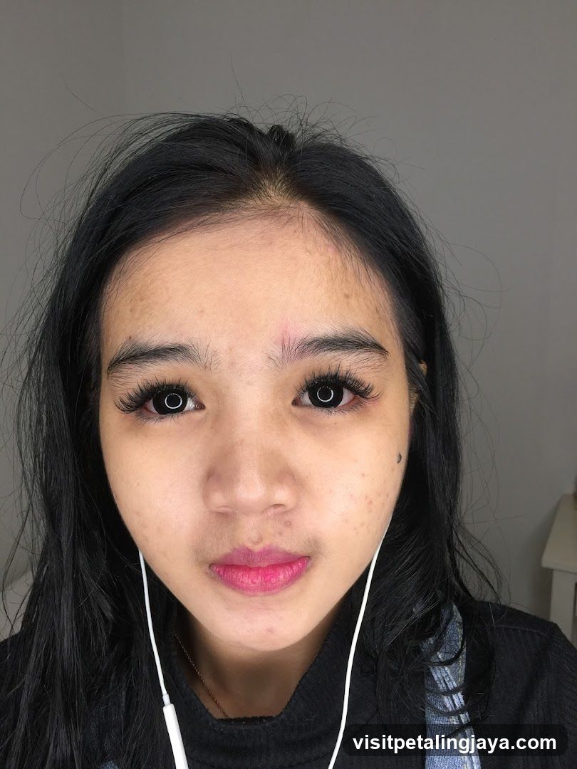 Portrait of a person with makeup and earphones