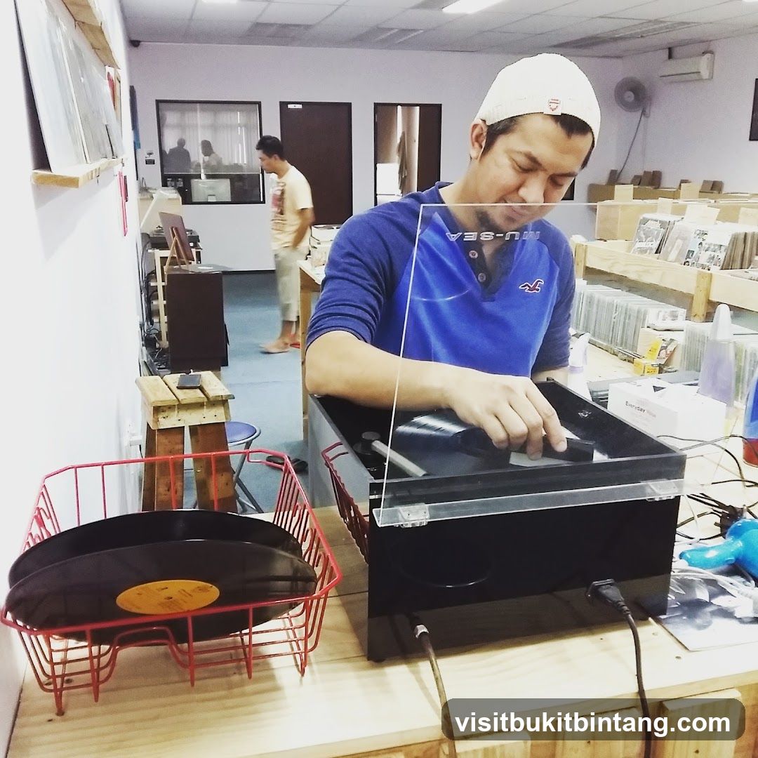 Man cleaning a vinyl record