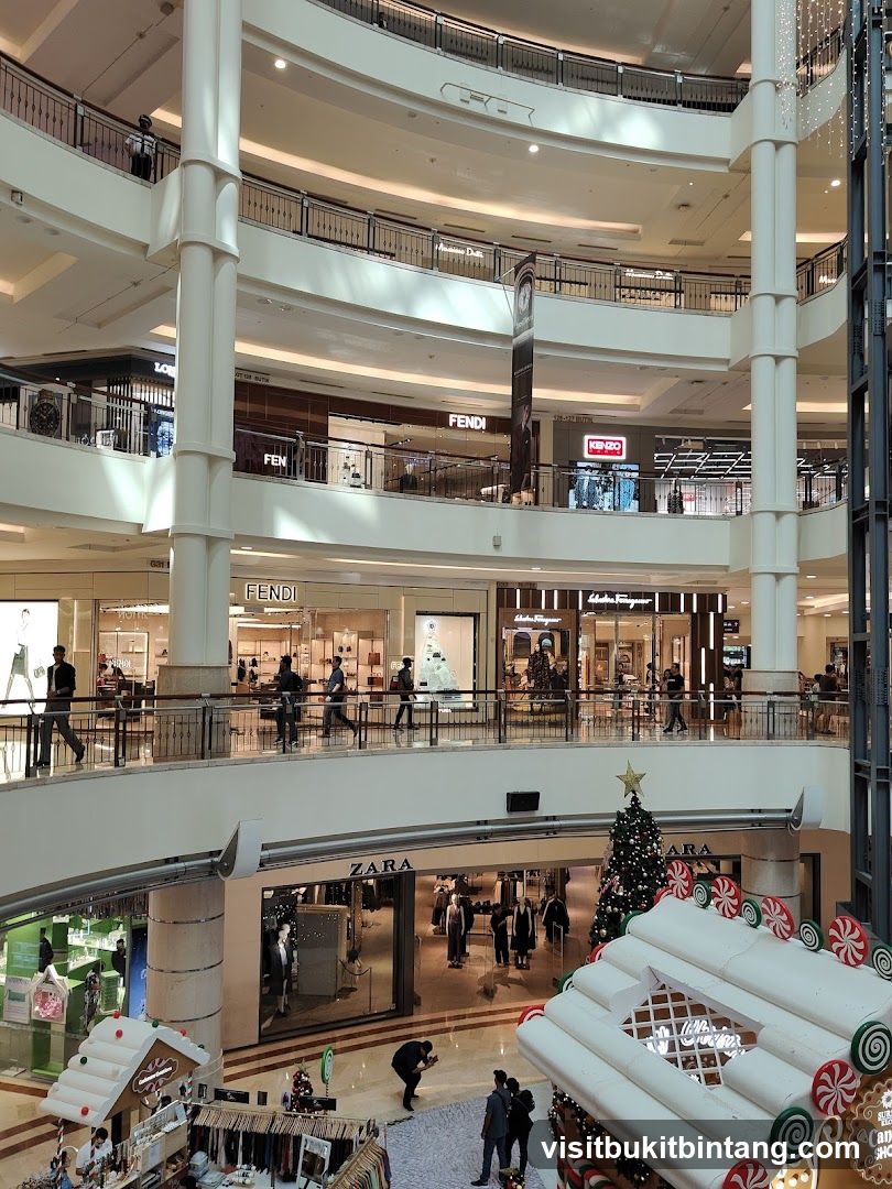 Multi-level shopping mall interior with Fendi and Zara stores