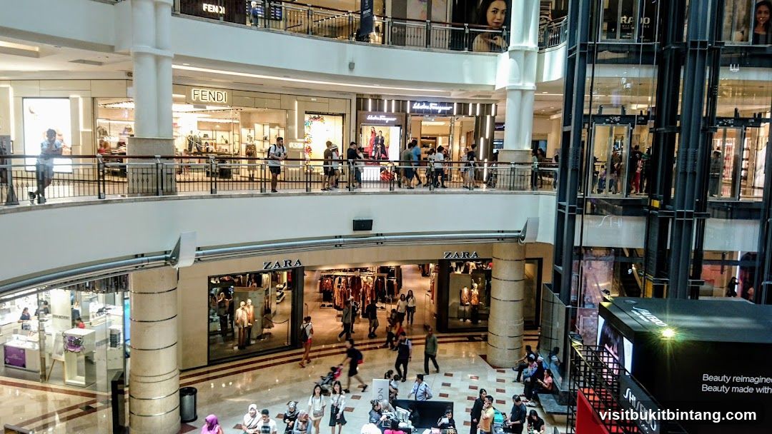 Busy shopping mall interior with multiple levels and stores