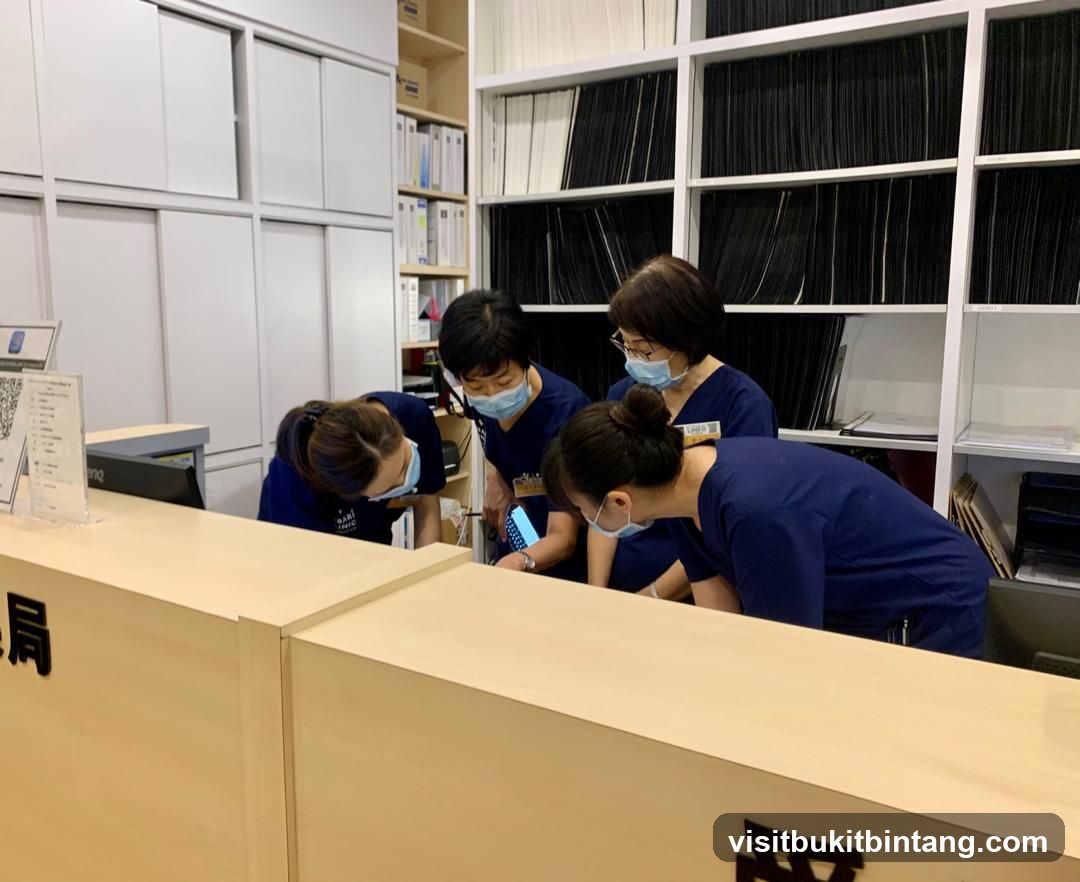 Staff gathered around a phone at a reception desk