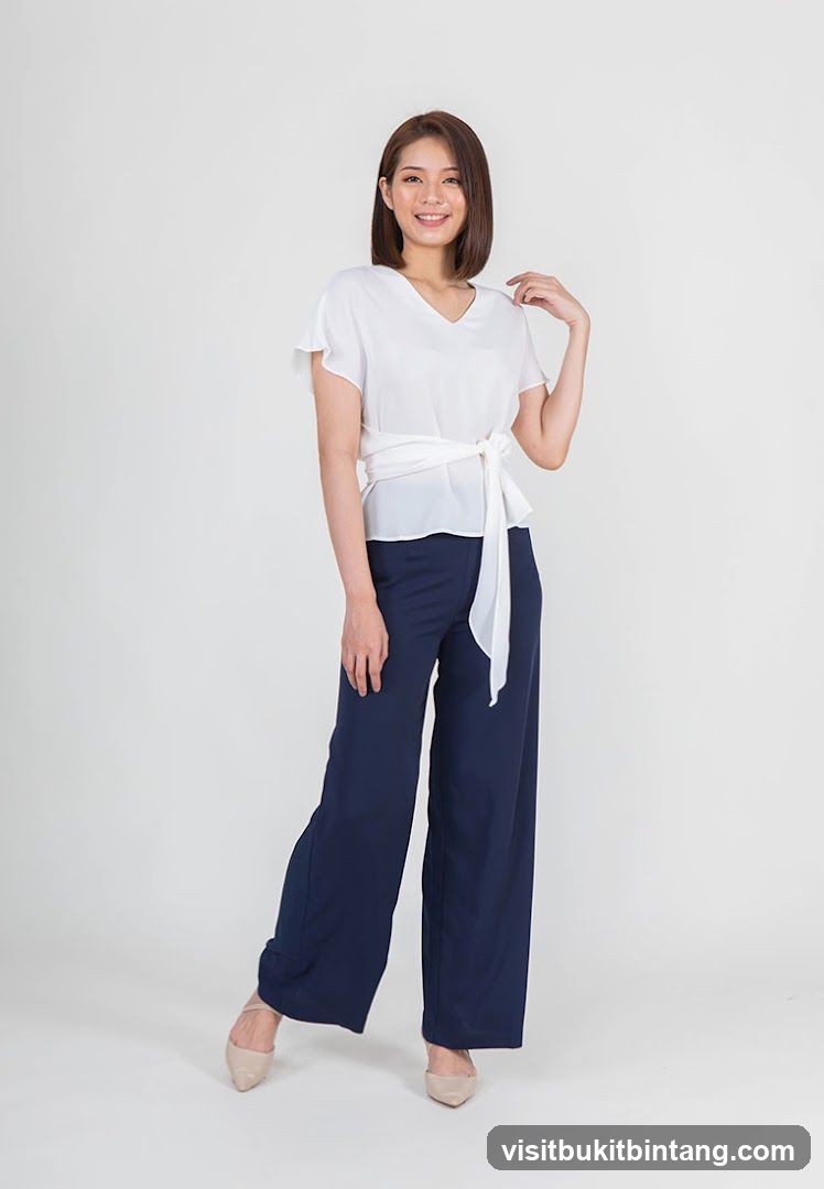 Woman in white top and navy pants