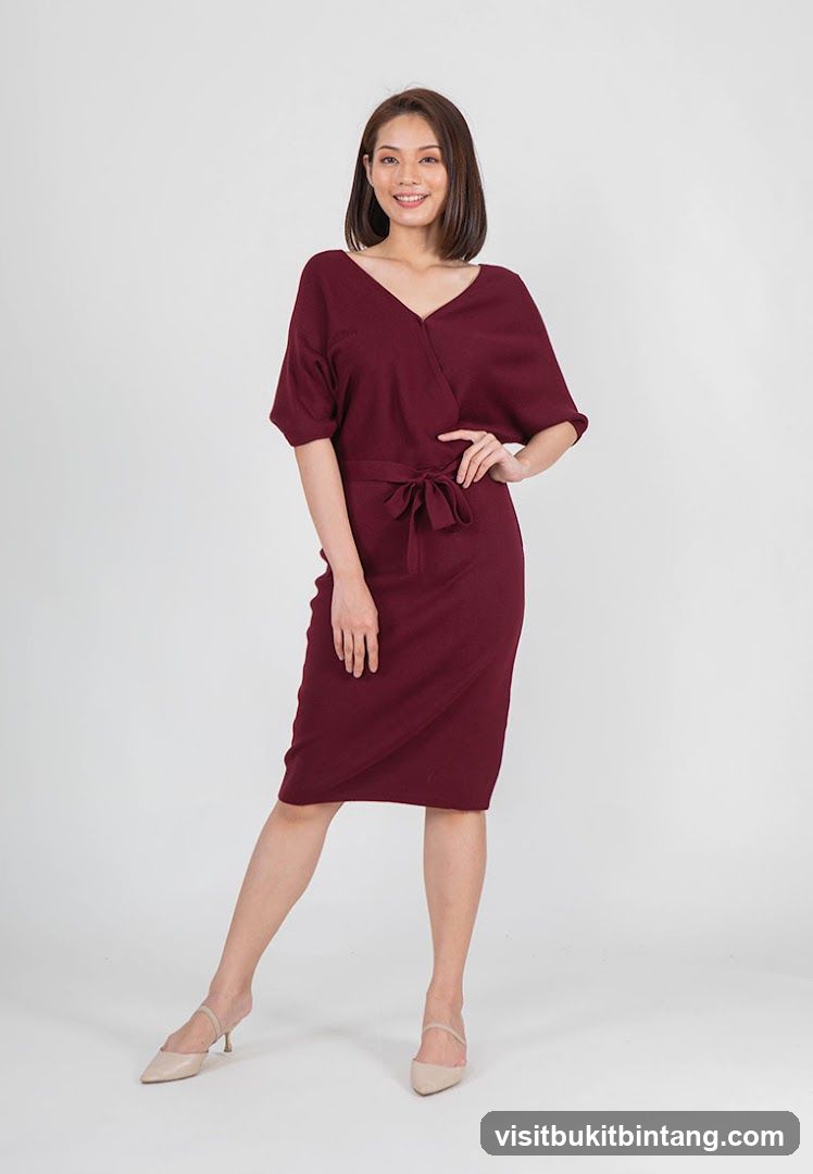 Woman in a maroon wrap dress