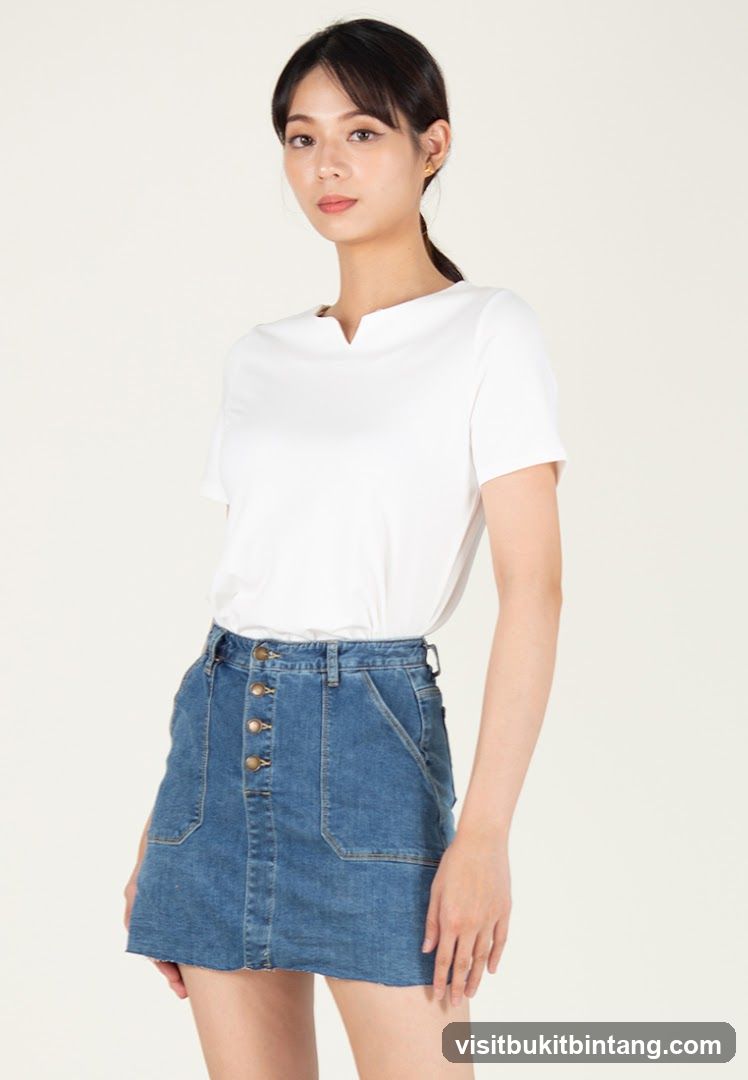 Woman in white top and denim skirt