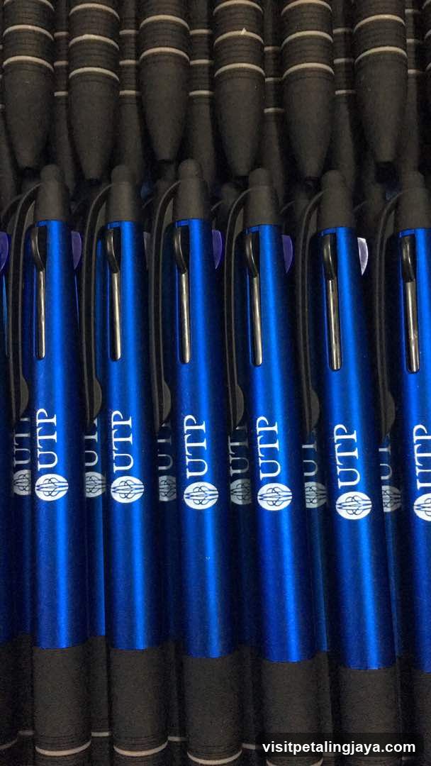 Blue branded pens in bulk packaging