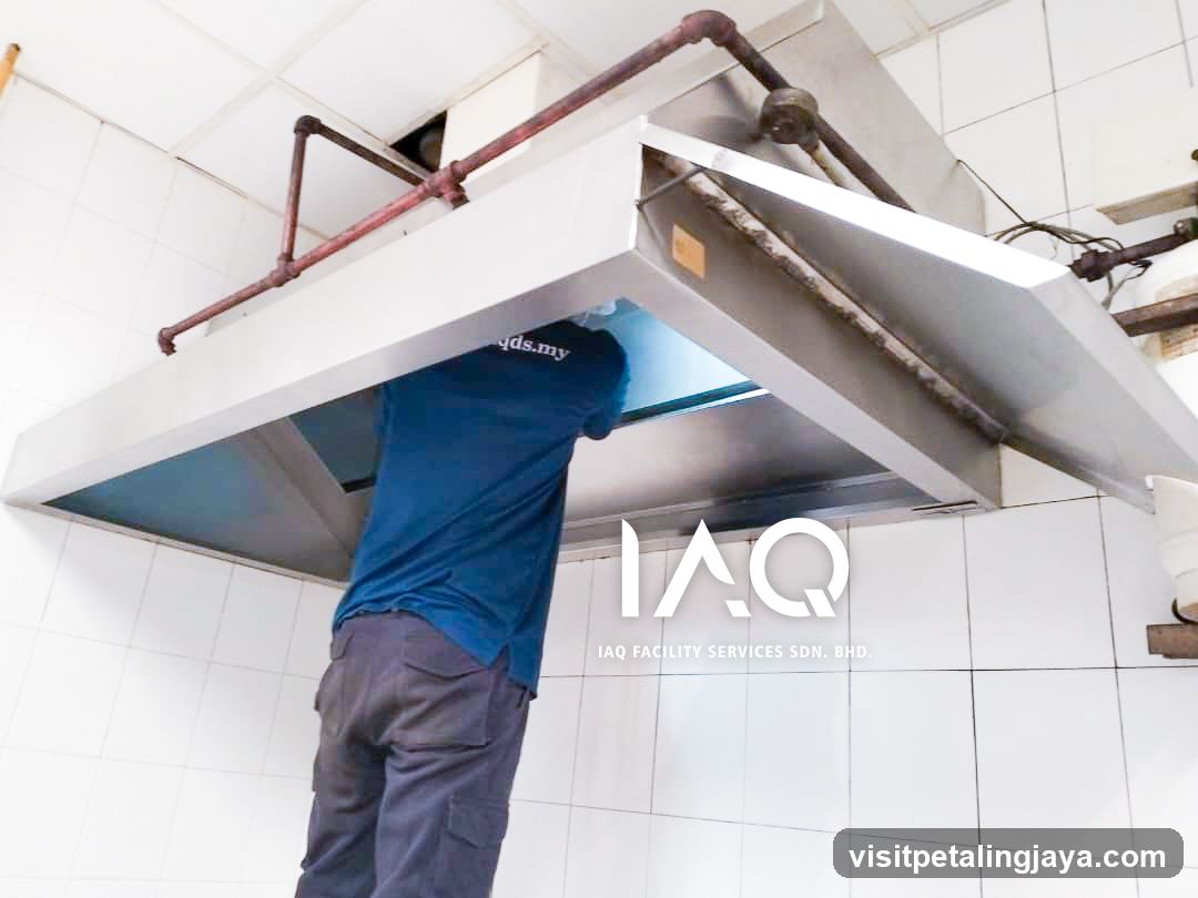 IAQ Facility Services Worker Cleaning Hood