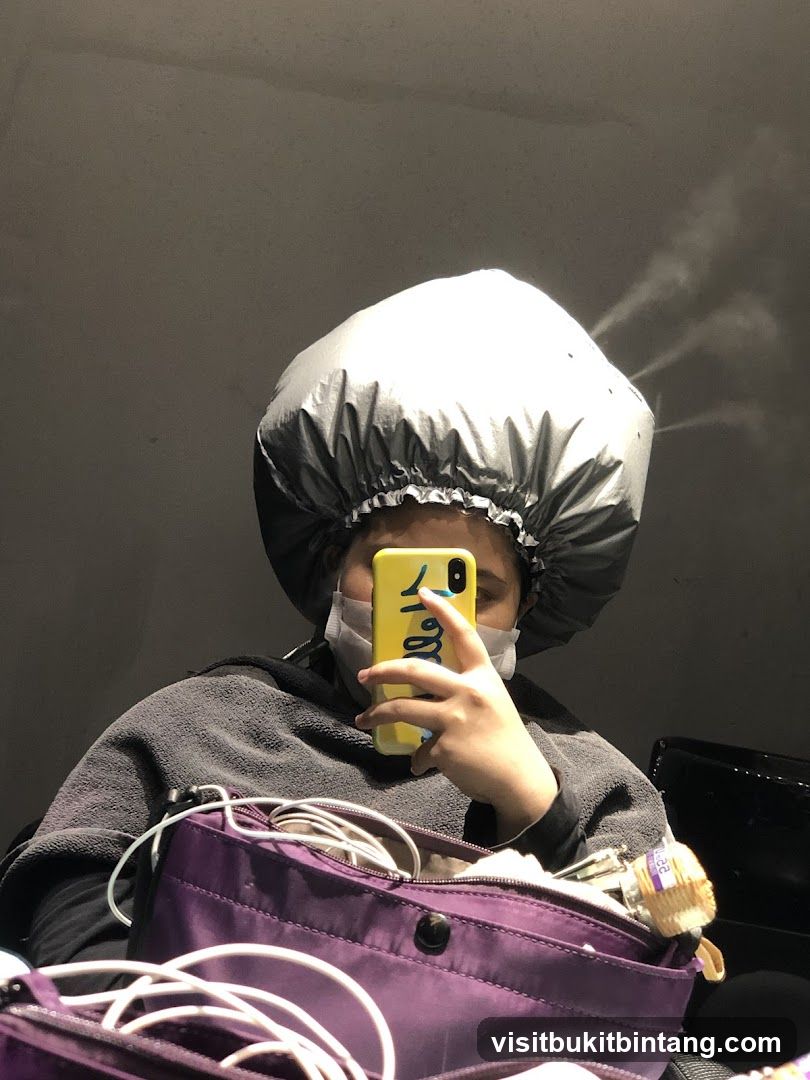 Woman with hair steamer
