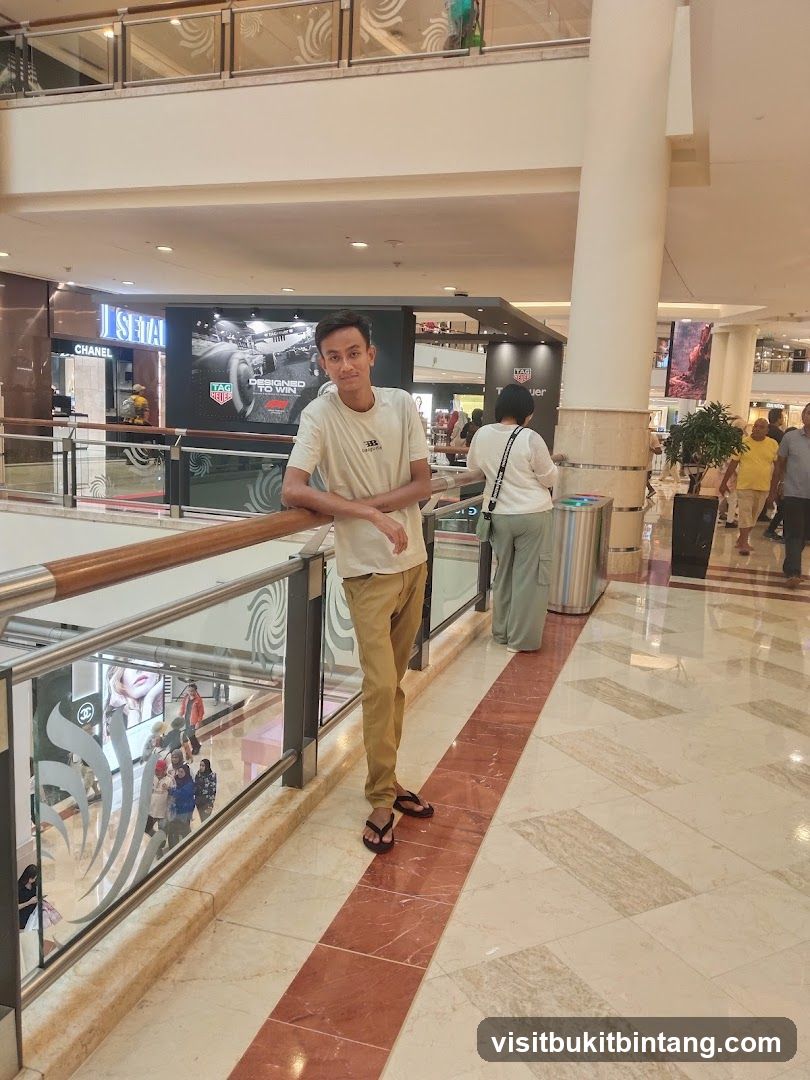 Man leaning on railing in mall