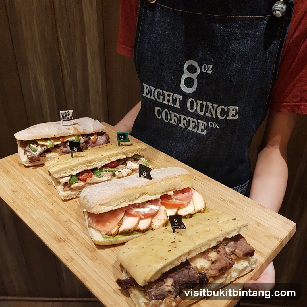 Four Sandwiches on a Wooden Board