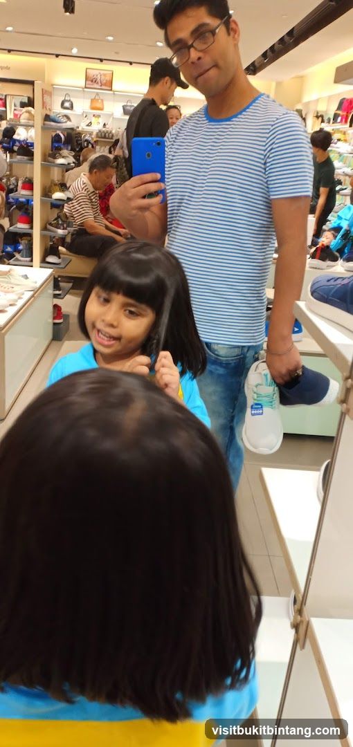 Man and children in a shoe store
