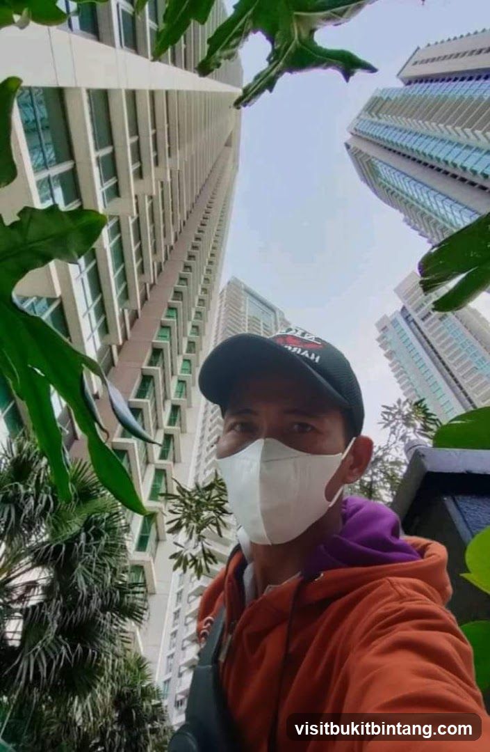Man in face mask and cap with skyscrapers in background